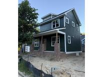 New construction two-story home with dark siding, white trim, brick foundation and porch columns at 2662 Lawndale Ave, Durham, NC 27705