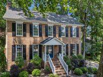Charming brick home with black shutters, white trim, and landscaped front yard at 2901 Ceremonial Ct, Raleigh, NC 27615