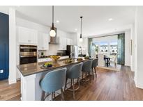 Modern kitchen features a spacious island with seating and stainless steel appliances at 3104 Kempthorne Rd # 48, Cary, NC 27519