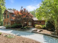 Charming home featuring a well-manicured front yard with mature landscaping, a gravel driveway and a welcoming entrance at 4312 Mystic Ln, Hillsborough, NC 27278