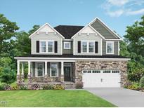 Charming two-story home with stone accents, covered porch, and lush green lawn at 444 Golden Dragonfly St, Wake Forest, NC 27587