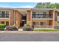 Charming condo with brick facade and cozy balcony; ideal for relaxing outdoors at 4709 Edwards Mill Rd # H, Raleigh, NC 27612