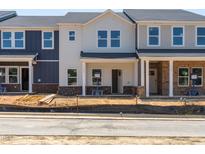 New townhomes featuring modern design and inviting entryways with brick accents at 717 Chandler Stone Dr, Zebulon, NC 27597