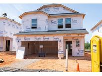 New construction home with Tyvek wrap shows two-story framing and open garage at 804 Ottawa Dr, Garner, NC 27529