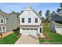 New construction home showcasing a white facade and two-car garage at 92 Horseshoe Pl # 9, Angier, NC 27501