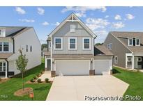 Charming two-story home with a spacious three car garage and landscaped front yard at 92 Horseshoe Pl # 9, Angier, NC 27501