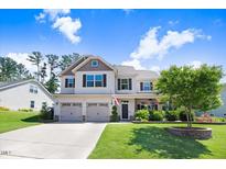 Charming two-story home featuring a two-car garage, landscaped yard and covered porch perfect for relaxing at 10 W Ravano Dr, Clayton, NC 27527