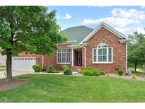 Charming brick home with lush lawn, mature tree, and manicured landscaping at 107 Regiment Way, Durham, NC 27705