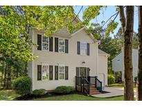 Charming two-story home with black shutters, landscaped yard, and a welcoming front porch at 112 Fairford Dr, Holly Springs, NC 27540