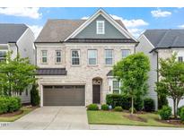 Charming two-story brick home with a two-car garage and well-manicured landscaping at 113 Mazarin Ln, Cary, NC 27519