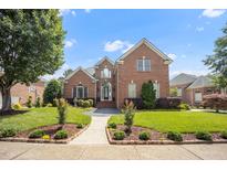 Beautiful brick two-story home featuring a landscaped front yard and inviting entranceway at 12140 Pawleys Mill Cir, Raleigh, NC 27614