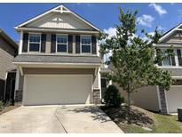 Two story home with attached two car garage, and landscaping on a clear day at 133 Explorer Dr # 258, Morrisville, NC 27560