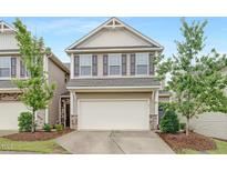 Charming two-story home featuring a two-car garage, neutral siding, and manicured front yard at 133 Explorer Dr # 258, Morrisville, NC 27560