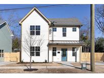 Charming two-story home with white siding, a blue front door, and a well-maintained yard at 1514 W Knox St, Durham, NC 27705