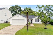 Charming single-Gathering home with attached garage and manicured front lawn featuring mature palm tree at 1725 E Honey Springs Ave, Fuquay Varina, NC 27526