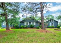 Charming single-story home featuring a blue exterior, white shutters, and a well-maintained front lawn at 1732 Farmington Rd, Rocky Mount, NC 27801