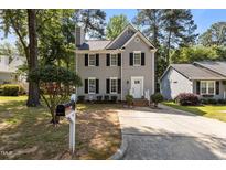 Charming two-story home with well-maintained landscaping and a classic design at 203 Kronos Lane, Cary, NC 27513
