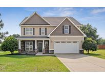 Charming two-story home with a well-maintained lawn, inviting entrance, and attached two-car garage at 206 Wynngate Dr, Cameron, NC 28326
