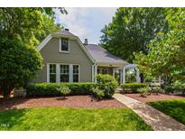 Charming two-story home with brick exterior, inviting front porch, and lush landscaping at 2202 St Marys St, Raleigh, NC 27608