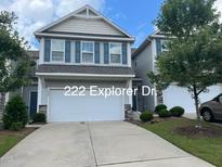 Charming two-story home featuring a two-car garage, blue shutters, and a well-manicured lawn at 222 Explorer Dr # 271, Morrisville, NC 27560