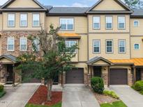 Inviting townhome exterior with a well-maintained lawn and tasteful landscaping showcasing the architecture at 2609 Stewart Pines Dr, Raleigh, NC 27615