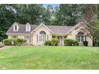 Charming brick home featuring manicured lawn and mature trees in a desirable neighborhood at 3 Bent Oak Ct, Durham, NC 27705