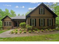 Charming Craftsman-style home with meticulously landscaped front yard and inviting entrance at 31 River View Ct, Timberlake, NC 27583