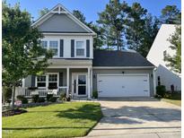 Charming two-story home with a well-manicured lawn, a two-car garage, and a welcoming front porch at 312 Crusaders Dr, Morrisville, NC 27560