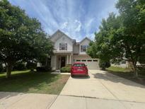 Charming two-story home featuring a two-car garage, well-maintained lawn, and mature trees at 3927 Wedonia Dr, Cary, NC 27519