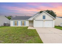 Charming single-Gathering home featuring a two-car garage and well-maintained front lawn at sunset at 503 Kinship Ln, Apex, NC 27502