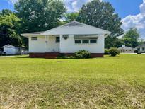 Charming single-story home with white siding and a well-maintained front lawn at 508 E Mcneill St, Lillington, NC 27546