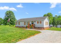 Charming single-story home with light blue siding, wood shutters, and a well-maintained front yard at 724 Harolds Northfield Dr, Cedar Grove, NC 27231