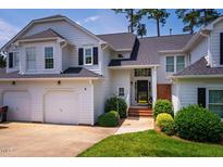 Charming two-story home with attached garage, manicured lawn and inviting entrance at 9 Lake Village Dr, Durham, NC 27713