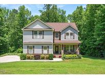 Charming two-story home with manicured lawn and landscaping at 110 Lexington Ave, Zebulon, NC 27597