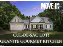Charming single-story home featuring a two-car garage and beautifully landscaped front yard in a cul-de-sac setting at 123 Holiday Island Dr, Garner, NC 27529