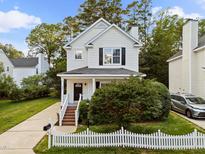 Charming two-story home features a well-maintained lawn and inviting front porch at 131 Cricketgrass Dr, Cary, NC 27513