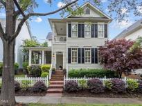 Charming two-story home with a manicured front yard, picket fence, and inviting curb appeal at 1711 Happiness Hill Ln, Raleigh, NC 27614