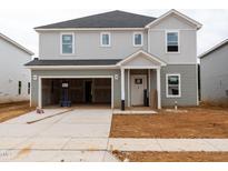 Under construction, two-story home boasts a two-car garage, neutral siding, and a modern design at 2242 Cherry Creek Rd, Haw River, NC 27258