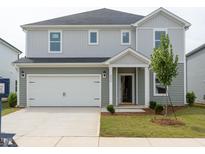 Charming two-story home with a two-car garage and landscaped front yard at 2242 Cherry Creek Rd, Haw River, NC 27258