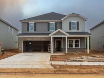 Two-story home featuring gray siding, brick accents, and an attached two-car garage at 2246 Cherry Creek Rd, Haw River, NC 27258