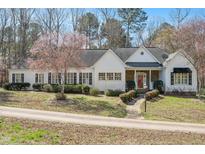 Charming one-story home with manicured landscaping, stone accents, and blooming trees at 2420 Mollynick Ln, Wake Forest, NC 27587