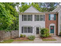Charming two-story townhouse with white siding, black shutters, and a well-maintained front yard at 314 Virens Dr, Cary, NC 27511