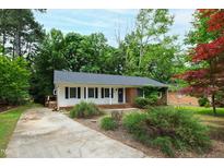 Charming single-story home featuring a well-maintained front yard with mature trees and traditional design elements at 3517 Morningside Dr, Raleigh, NC 27607