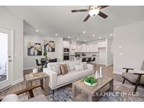 Modern living room featuring neutral tones, stylish furniture, and an open layout connecting to the kitchen at 3924 Well Fleet Dr, Fuquay Varina, NC 27526