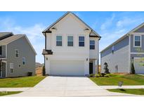 Charming two-story home with a two car garage and well-manicured lawn on a bright, sunny day at 5113 Ranger Grove Way, Raleigh, NC 27604