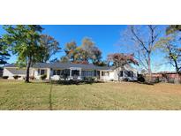 Charming single-story home featuring a well-manicured lawn and mature trees at 526 N Fairview Rd, Rocky Mount, NC 27801