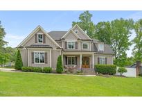 Charming two-story home with a manicured lawn and beautiful landscaping, creating a welcoming curb appeal at 5308 Montclair Dr, Raleigh, NC 27609