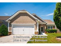 Charming home featuring shake siding, stone accents, a two-car garage, and manicured lawn at 740 Blackfriars Loop, Cary, NC 27519