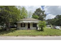 Quaint single-story home with a metal roof and covered front porch, needs work at 752 Nashville Rd, Rocky Mount, NC 27803