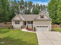 Charming home with a well-manicured lawn, a two-car garage and delightful curb appeal at 105 Old Barn Way, Wendell, NC 27591